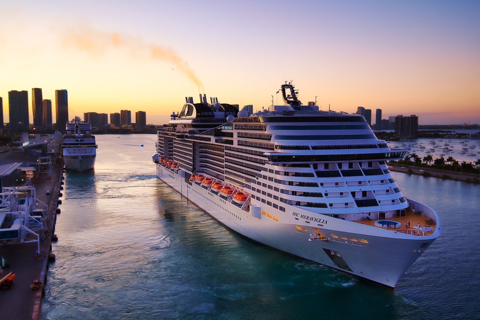 MSC cruise ship sailing past the Miami skyline at sunset, one of many last minute cruise deals from Florida