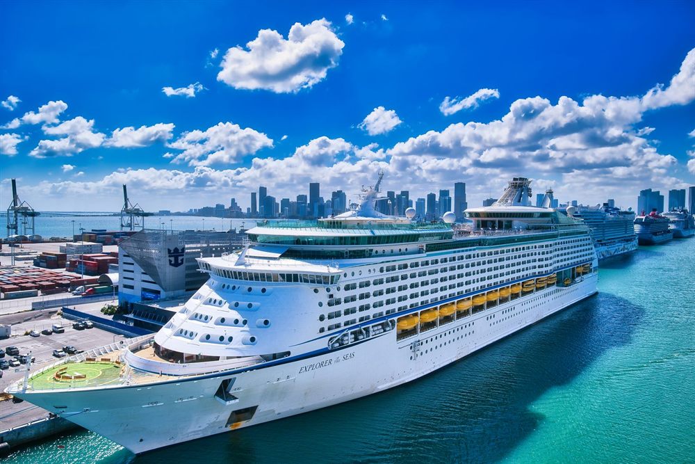 Cruise ship docked in Miami beside downtown skyscrapers